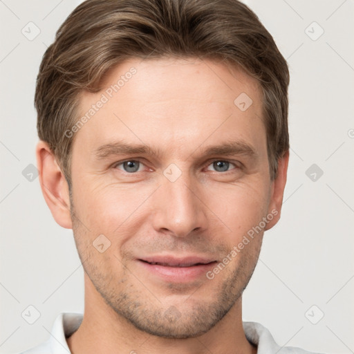 Joyful white adult male with short  brown hair and grey eyes