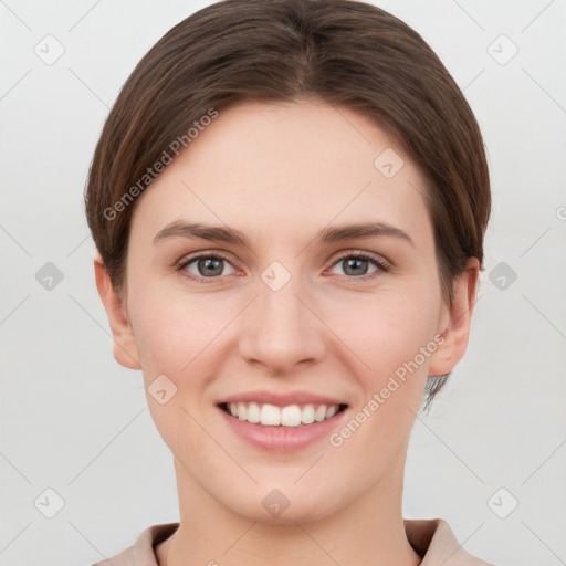 Joyful white young-adult female with short  brown hair and grey eyes