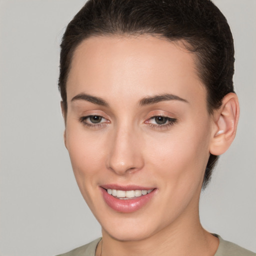 Joyful white young-adult female with short  brown hair and brown eyes