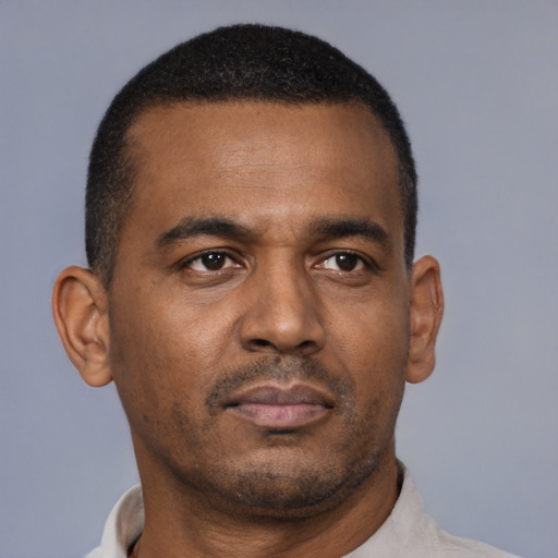 Neutral latino adult male with short  brown hair and brown eyes