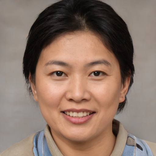 Joyful white adult female with medium  brown hair and brown eyes