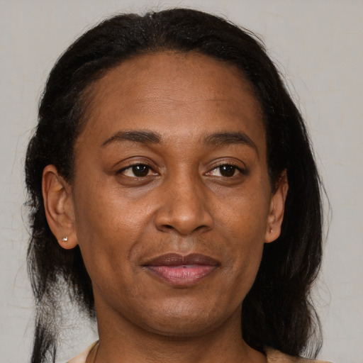 Joyful black adult female with medium  brown hair and brown eyes