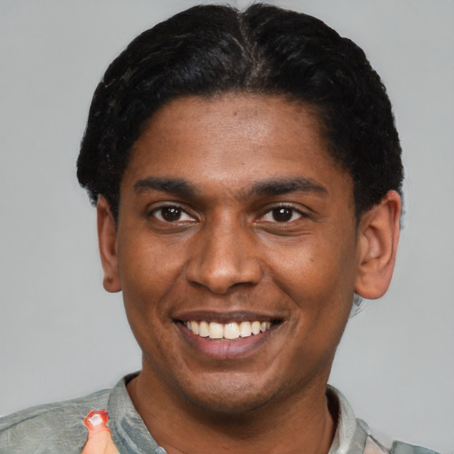 Joyful latino young-adult male with short  black hair and brown eyes