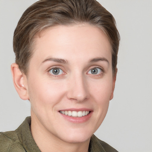 Joyful white young-adult female with short  brown hair and grey eyes