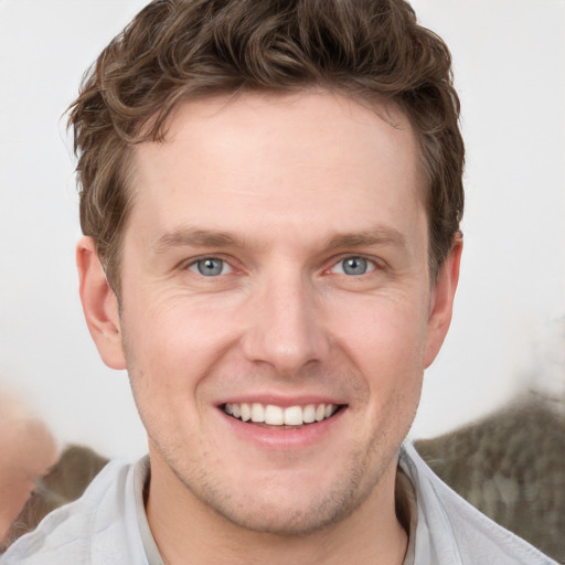 Joyful white adult male with short  brown hair and grey eyes