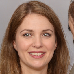 Joyful white adult female with long  brown hair and brown eyes