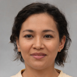 Joyful white adult female with medium  brown hair and brown eyes