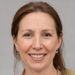 Joyful white adult female with medium  brown hair and grey eyes