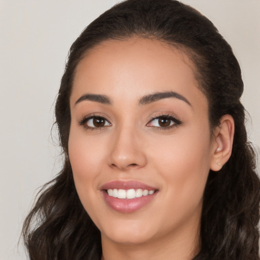 Joyful white young-adult female with long  black hair and brown eyes