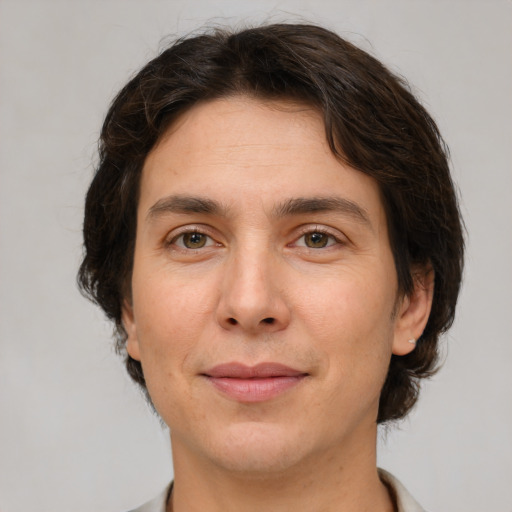 Joyful white adult male with medium  brown hair and brown eyes