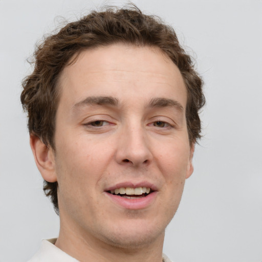 Joyful white adult male with short  brown hair and grey eyes