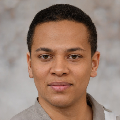 Joyful latino young-adult male with short  brown hair and brown eyes