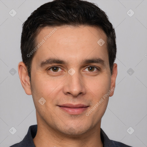 Joyful white young-adult male with short  black hair and brown eyes