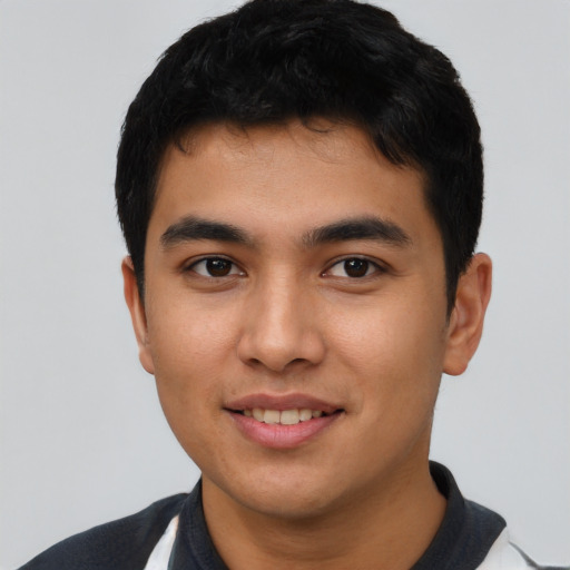 Joyful asian young-adult male with short  black hair and brown eyes