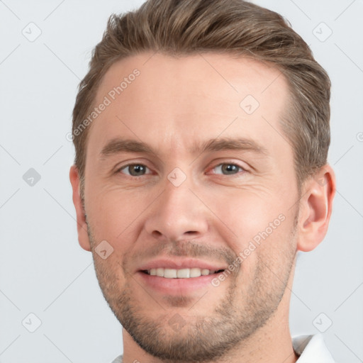 Joyful white young-adult male with short  brown hair and grey eyes