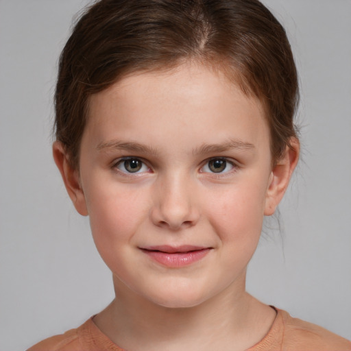 Joyful white child female with short  brown hair and brown eyes