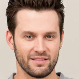 Joyful white young-adult male with short  brown hair and brown eyes