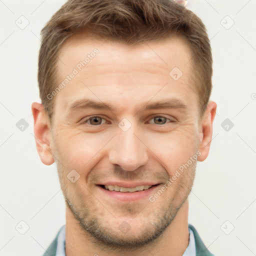 Joyful white young-adult male with short  brown hair and grey eyes