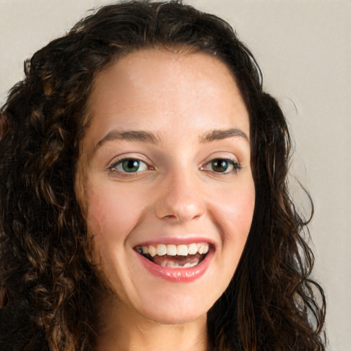 Joyful white young-adult female with long  brown hair and green eyes