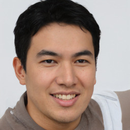 Joyful latino young-adult male with short  brown hair and brown eyes