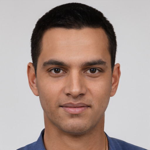 Joyful white young-adult male with short  black hair and brown eyes