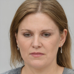 Joyful white adult female with medium  brown hair and blue eyes