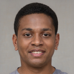 Joyful latino young-adult male with short  brown hair and brown eyes