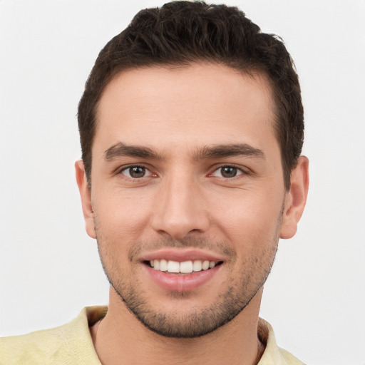 Joyful white young-adult male with short  brown hair and brown eyes