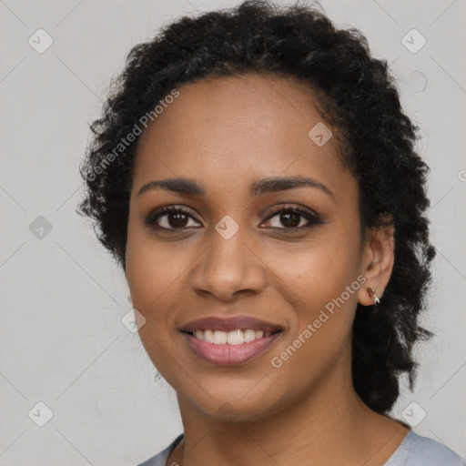 Joyful black young-adult female with long  brown hair and brown eyes