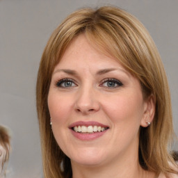 Joyful white young-adult female with medium  brown hair and blue eyes