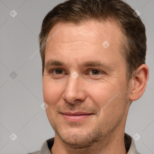 Joyful white adult male with short  brown hair and brown eyes