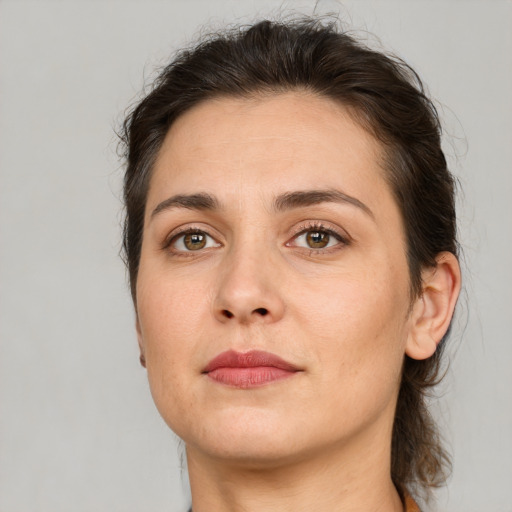 Joyful white adult female with short  brown hair and brown eyes