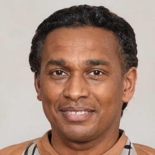 Joyful latino adult male with short  black hair and brown eyes