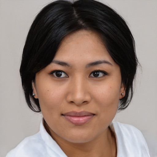 Joyful asian young-adult female with medium  black hair and brown eyes