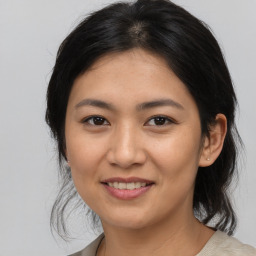 Joyful asian young-adult female with medium  brown hair and brown eyes