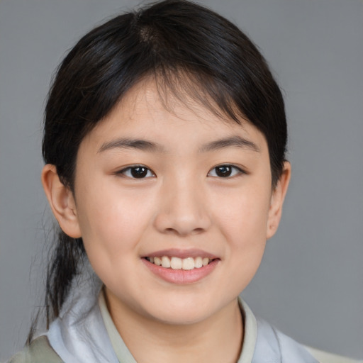 Joyful white child female with medium  brown hair and brown eyes