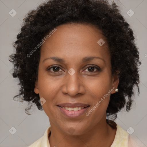 Joyful black adult female with short  brown hair and brown eyes