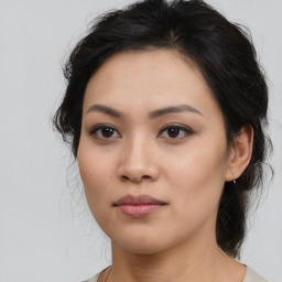 Joyful asian young-adult female with medium  brown hair and brown eyes