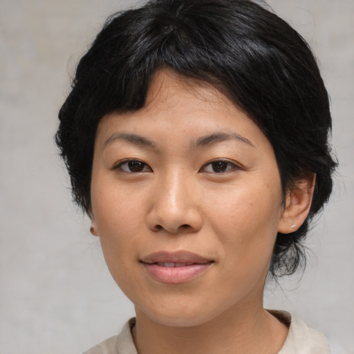 Joyful asian young-adult female with medium  brown hair and brown eyes