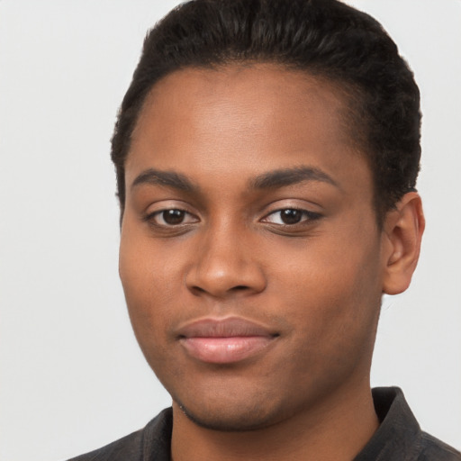 Joyful black young-adult male with short  black hair and brown eyes