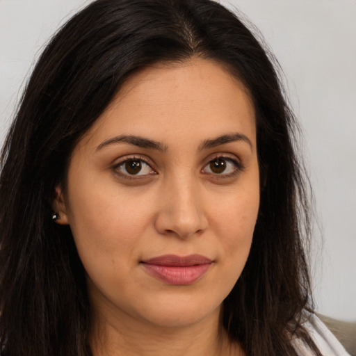 Joyful latino young-adult female with long  brown hair and brown eyes