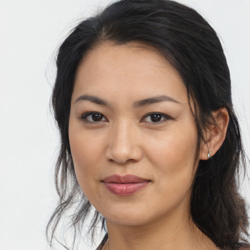 Joyful asian young-adult female with long  brown hair and brown eyes
