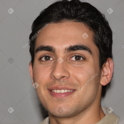 Joyful white young-adult male with short  black hair and brown eyes