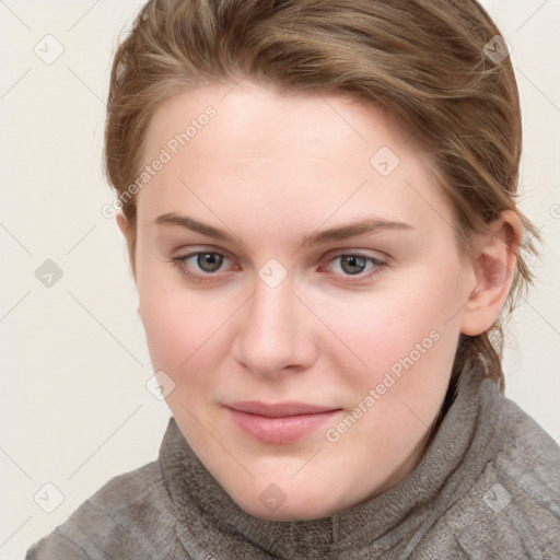 Joyful white young-adult female with short  brown hair and blue eyes