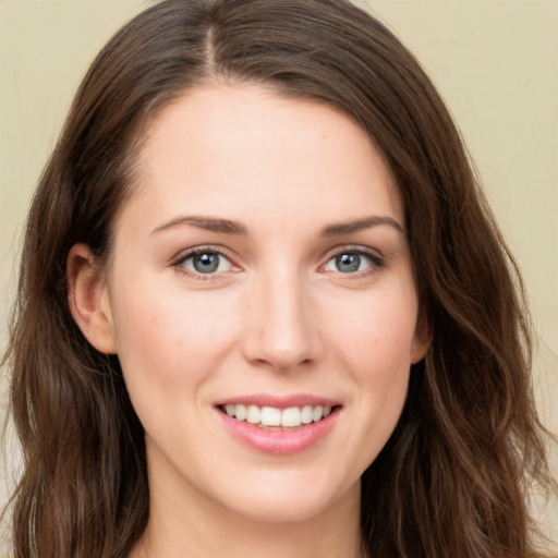 Joyful white young-adult female with long  brown hair and green eyes