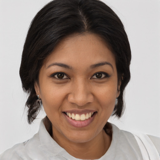 Joyful latino young-adult female with medium  brown hair and brown eyes