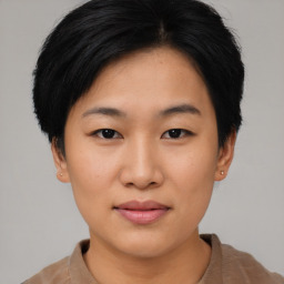 Joyful asian young-adult female with short  black hair and brown eyes