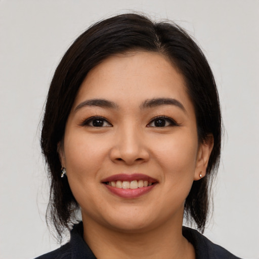Joyful asian young-adult female with medium  black hair and brown eyes