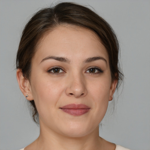 Joyful white young-adult female with medium  brown hair and brown eyes