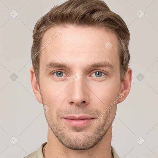 Joyful white young-adult male with short  brown hair and grey eyes